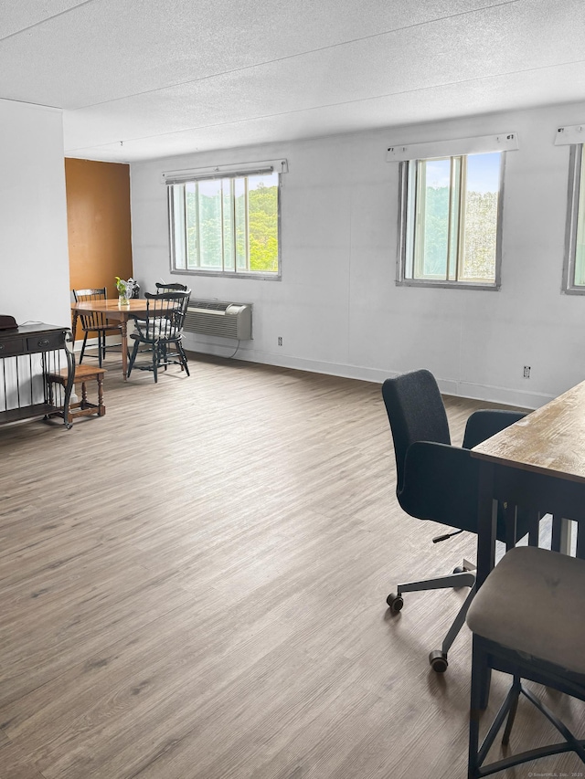 120 Huntington Tpke Unit 606, Bridgeport, CT 06610 - office area with wood finished floors, a wall mounted AC, and a textured ceiling