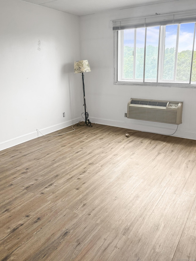 120 Huntington Tpke Unit 606, Bridgeport, CT 06610 - spare room featuring wood finished floors and a wall unit AC