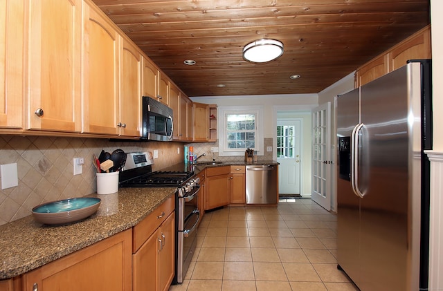 37 Lamplighter Ln, Fairfield, CT 06825 - kitchen featuring appliances with stainless steel finishes, wooden ceiling, light tile patterned floors, dark stone countertops, and tasteful backsplash