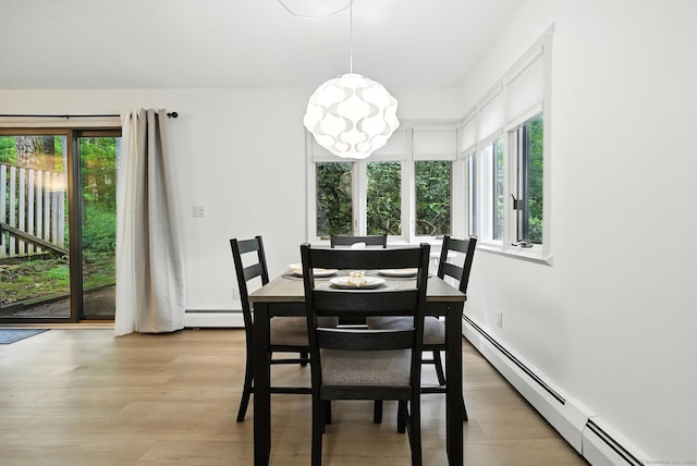 4 Earls Ct Unit 4C, Farmington, CT 06032 - dining area with a baseboard heating unit, light wood-type flooring, and a chandelier