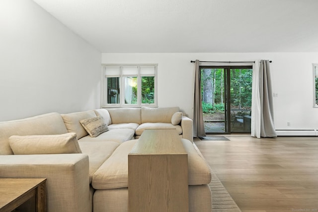 4 Earls Ct Unit 4C, Farmington, CT 06032 - living area with a baseboard radiator, wood finished floors, and healthy amount of natural light