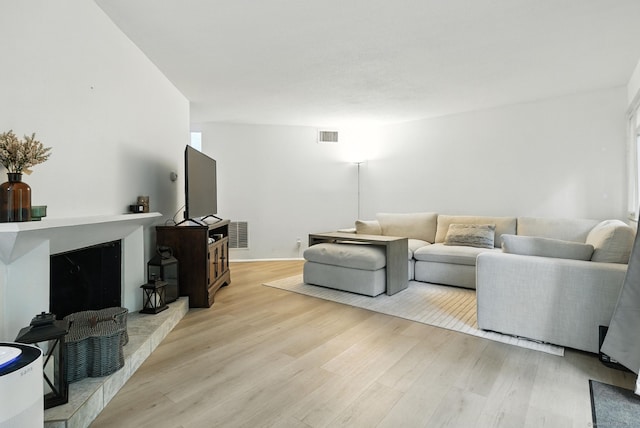 4 Earls Ct Unit 4C, Farmington, CT 06032 - living room featuring light wood-style floors and a high end fireplace