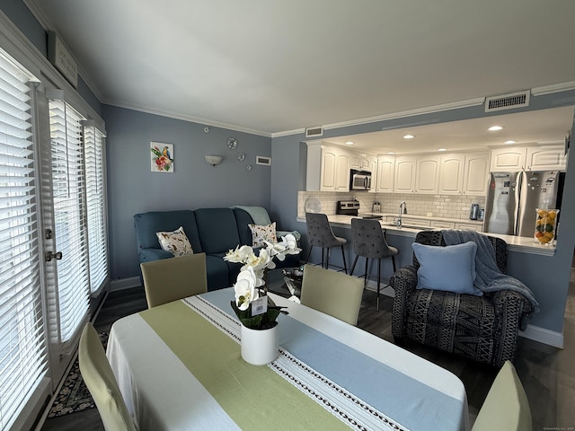 3250 Fairfield Ave Apt 100, Bridgeport, CT 06605 - dining space with plenty of natural light, ornamental molding, dark wood finished floors, and recessed lighting
