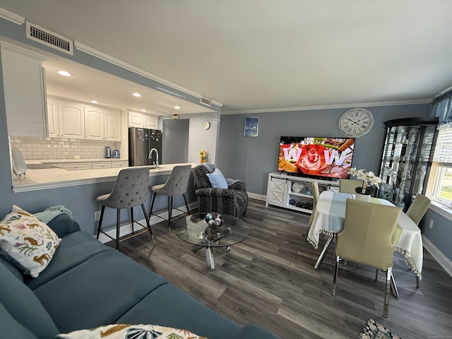 3250 Fairfield Ave Apt 100, Bridgeport, CT 06605 - living area with dark wood-style floors, ornamental molding, and recessed lighting