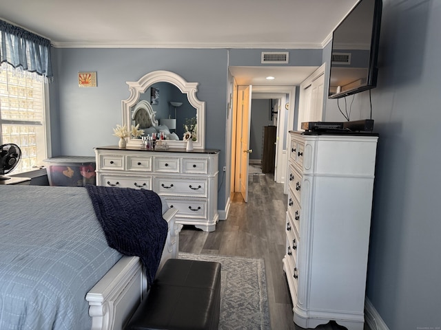 3250 Fairfield Ave Apt 100, Bridgeport, CT 06605 - bedroom featuring ornamental molding and dark wood-style flooring
