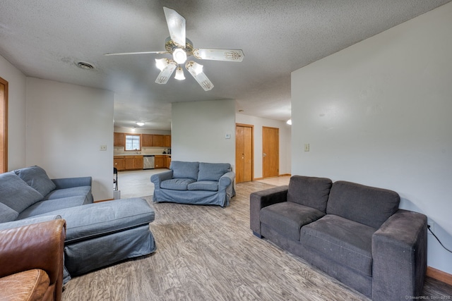 295 Hunting Lodge Rd, Mansfield, CT 06268 - living area featuring light wood-style floors, a ceiling fan, and a textured ceiling