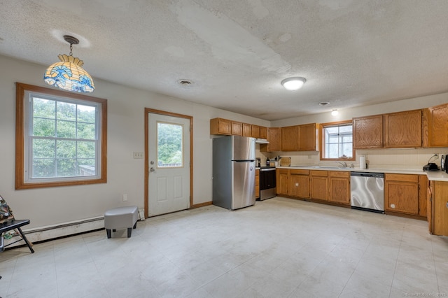 295 Hunting Lodge Rd, Mansfield, CT 06268 - kitchen featuring stainless steel appliances, baseboard heating, brown cabinetry, light countertops, and a textured ceiling
