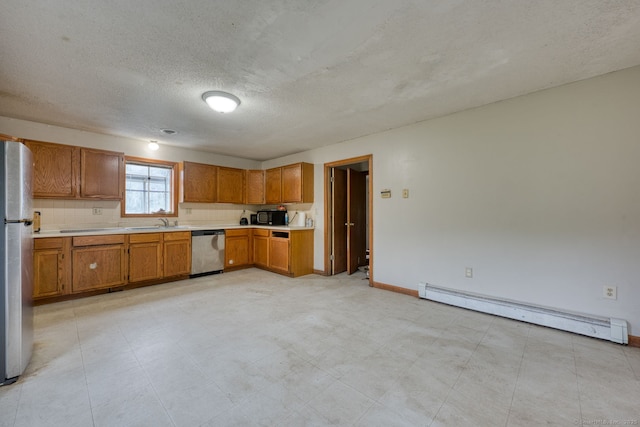 295 Hunting Lodge Rd, Mansfield, CT 06268 - kitchen with stainless steel appliances, a baseboard heating unit, light countertops, brown cabinetry, and a textured ceiling