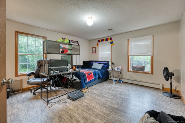 295 Hunting Lodge Rd, Mansfield, CT 06268 - bedroom featuring a baseboard heating unit, wood finished floors, and a textured ceiling