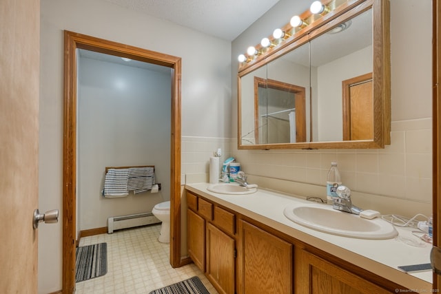 295 Hunting Lodge Rd, Mansfield, CT 06268 - bathroom with a baseboard heating unit, double vanity, and tile patterned floors