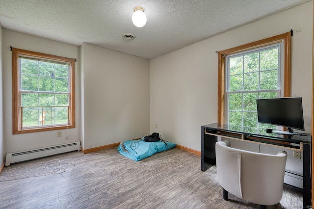 295 Hunting Lodge Rd, Mansfield, CT 06268 - home office with a baseboard heating unit, wood finished floors, healthy amount of natural light, and a textured ceiling