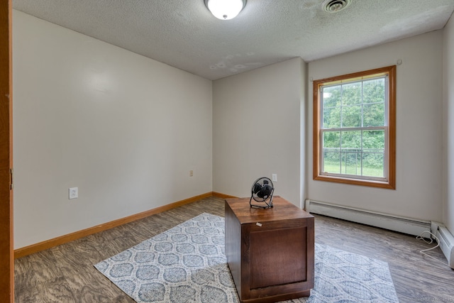 295 Hunting Lodge Rd, Mansfield, CT 06268 - office space with a baseboard heating unit, a textured ceiling, and wood finished floors