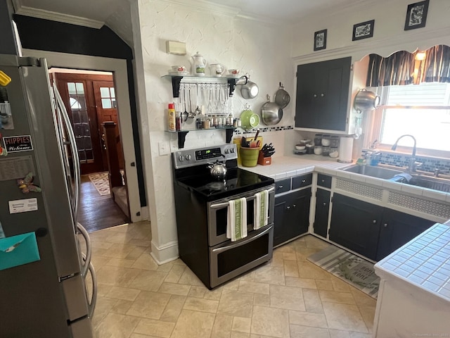 50 Wheeler Ter, Stratford, CT 06614 - kitchen with stainless steel appliances, tile countertops, ornamental molding, and light stone finish flooring