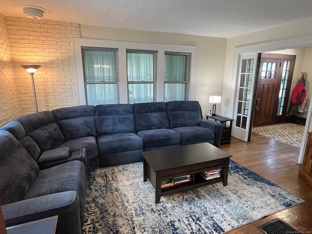 50 Wheeler Ter, Stratford, CT 06614 - living room featuring wood finished floors and brick wall