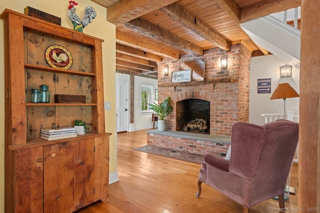 52 Aunt Park Ln, Newtown, CT 06470 - living area featuring a wood ceiling with exposed beams, wood finished floors, and a brick fireplace