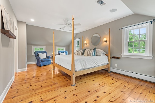 52 Aunt Park Ln, Newtown, CT 06470 - bedroom with lofted ceiling, light wood-type flooring, multiple windows, a baseboard heating unit, and a ceiling fan