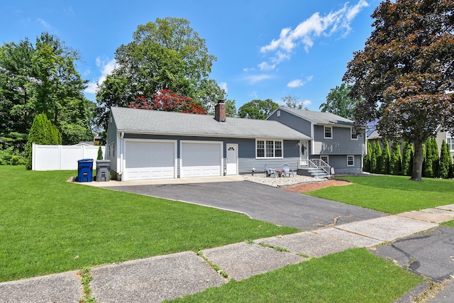 6 Bel Aire Dr, Plainville, CT 06062 - split level home featuring an attached garage, asphalt driveway, and a chimney
