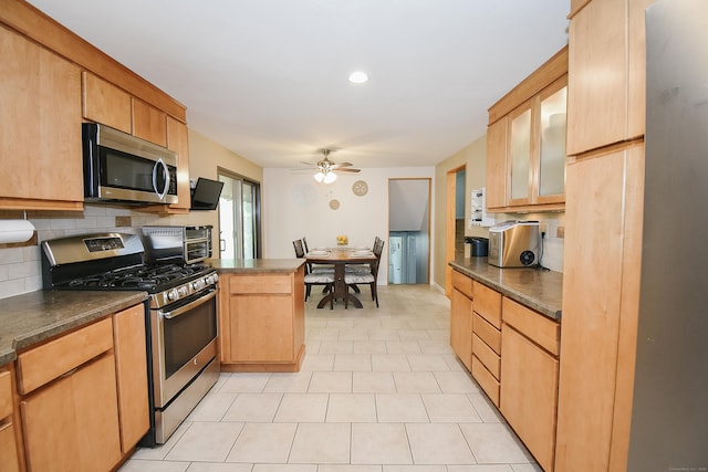 6 Bel Aire Dr, Plainville, CT 06062 - kitchen with appliances with stainless steel finishes, decorative backsplash, dark countertops, a ceiling fan, and glass insert cabinets