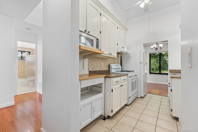 3 Stebbins Close Close Unit 3, Ridgefield, CT 06877 - kitchen with gas range gas stove, stainless steel microwave, under cabinet range hood, a chandelier, and white cabinets