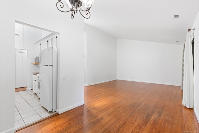 3 Stebbins Close Close Unit 3, Ridgefield, CT 06877 - unfurnished living room featuring a chandelier and light wood-style flooring