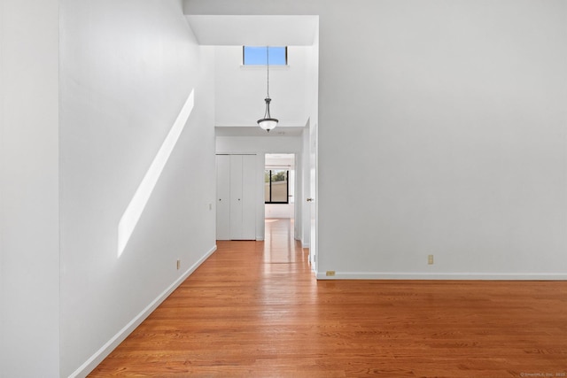 3 Stebbins Close Close Unit 3, Ridgefield, CT 06877 - unfurnished living room featuring a towering ceiling and light wood-style flooring