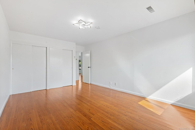 3 Stebbins Close Close Unit 3, Ridgefield, CT 06877 - unfurnished bedroom featuring multiple closets and wood finished floors