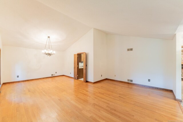 54 Timber Ln, Avon, CT 06001 - unfurnished room featuring a chandelier, lofted ceiling, light wood-style flooring, and a brick fireplace