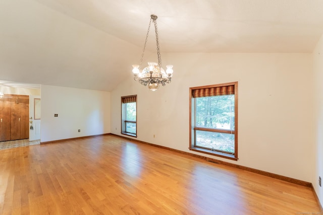 54 Timber Ln, Avon, CT 06001 - spare room with a chandelier, light wood-style flooring, and lofted ceiling