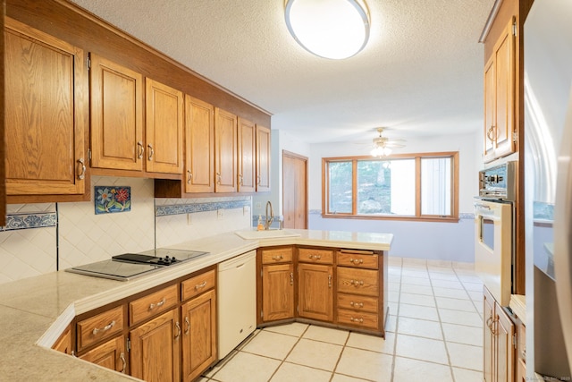 54 Timber Ln, Avon, CT 06001 - kitchen featuring white appliances, a peninsula, tasteful backsplash, light countertops, and light tile patterned floors