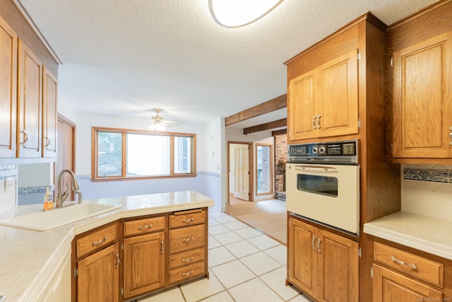 54 Timber Ln, Avon, CT 06001 - kitchen with white oven, light countertops, a peninsula, decorative backsplash, and ceiling fan