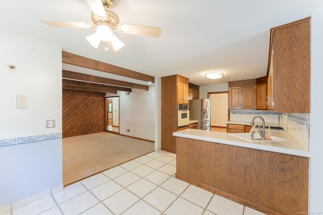 54 Timber Ln, Avon, CT 06001 - kitchen with oven, stainless steel fridge with ice dispenser, brown cabinets, a peninsula, and light countertops