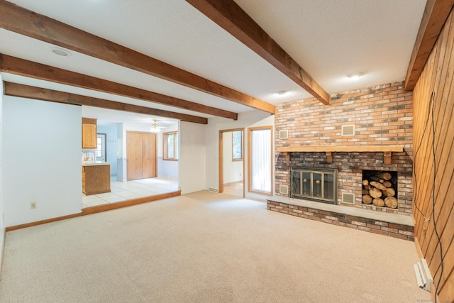 54 Timber Ln, Avon, CT 06001 - unfurnished living room with beamed ceiling, light carpet, a brick fireplace, and a ceiling fan