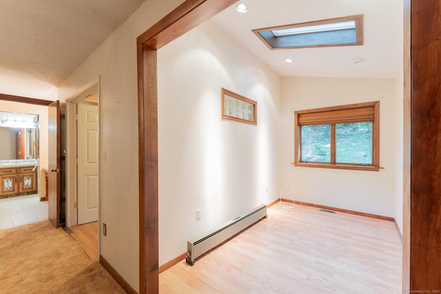 54 Timber Ln, Avon, CT 06001 - corridor with a baseboard heating unit, a skylight, light wood-style flooring, recessed lighting, and lofted ceiling
