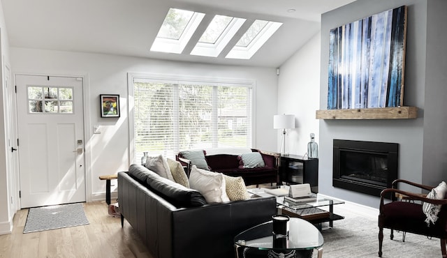 27 Mary Ln, Greenwich, CT 06878 - living area with vaulted ceiling, a skylight, a fireplace, and wood finished floors