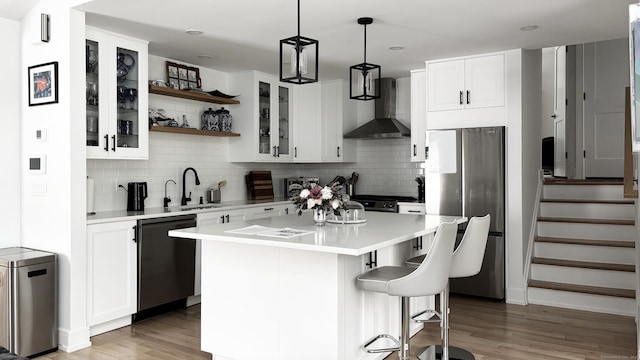 27 Mary Ln, Greenwich, CT 06878 - kitchen with wall chimney exhaust hood, freestanding refrigerator, dishwasher, wood finished floors, and tasteful backsplash