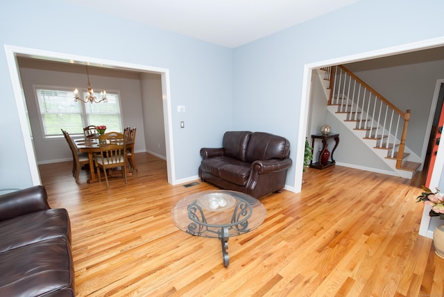 6 Fawn Meadow Dr, Naugatuck, CT 06770 - living area featuring a chandelier, light wood-style floors, and stairs
