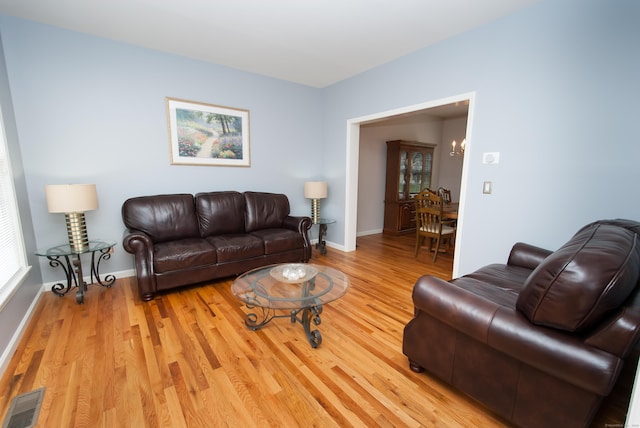 6 Fawn Meadow Dr, Naugatuck, CT 06770 - living area with light wood finished floors, healthy amount of natural light, and a chandelier
