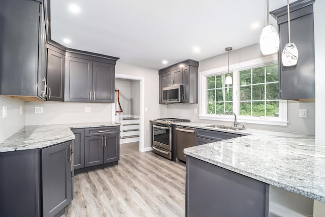 22 Lonetown Rd, Redding, CT 06896 - kitchen featuring appliances with stainless steel finishes, light stone countertops, light wood finished floors, decorative light fixtures, and recessed lighting