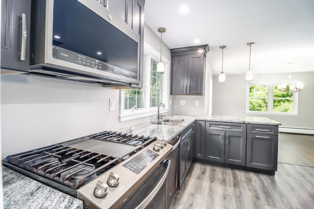 22 Lonetown Rd, Redding, CT 06896 - kitchen featuring stainless steel appliances, light wood-style floors, a peninsula, and light stone countertops