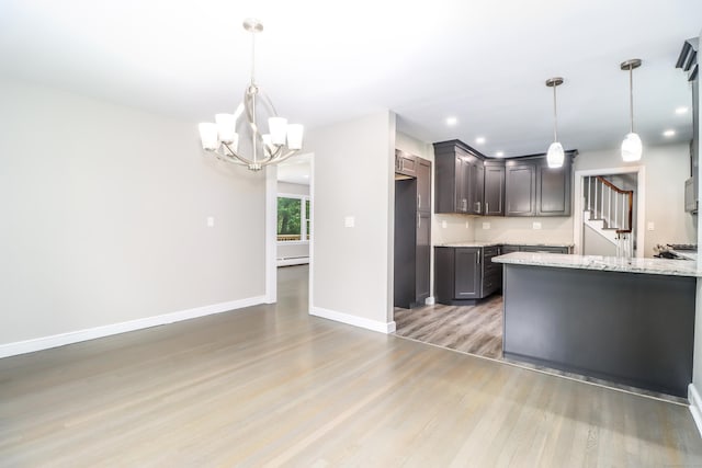 22 Lonetown Rd, Redding, CT 06896 - kitchen featuring light wood-style floors, a chandelier, light stone counters, a baseboard radiator, and recessed lighting