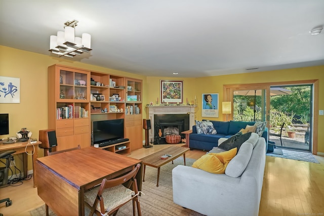 123 Old Belden Hill Rd Apt 24, Norwalk, CT 06850 - living area with light wood-type flooring, a fireplace with raised hearth, and a desk