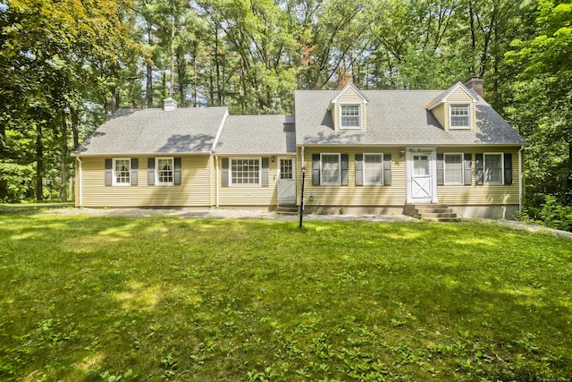 417 Billings Rd, Somers, CT 06071 - cape cod home with entry steps, a chimney, a front yard, and view of wooded area