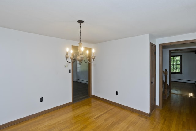 417 Billings Rd, Somers, CT 06071 - empty room with a baseboard heating unit, a chandelier, and light wood-type flooring