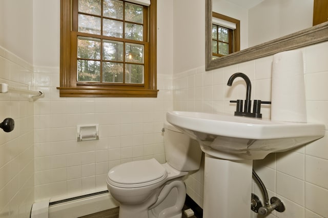 417 Billings Rd, Somers, CT 06071 - half bathroom with a baseboard radiator, tile walls, and a wainscoted wall