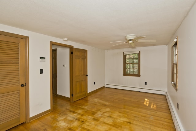 417 Billings Rd, Somers, CT 06071 - unfurnished room featuring a baseboard radiator, a ceiling fan, light wood finished floors, a smoke detector, and a baseboard heating unit