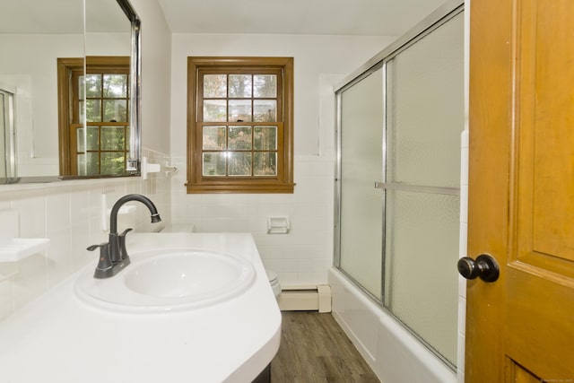 417 Billings Rd, Somers, CT 06071 - full bath with wood finished floors, a baseboard heating unit, shower / bath combination with glass door, vanity, and tile walls