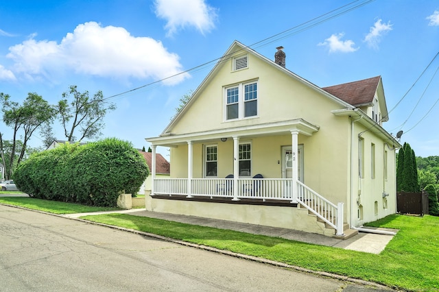 92 Yates St, West Haven, CT 06516 - view of front of house with covered porch, stucco siding, and a chimney
