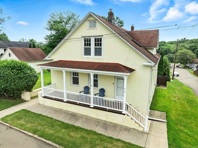 92 Yates St, West Haven, CT 06516 - view of front facade featuring a porch, stucco siding, a shingled roof, a chimney, and a front yard
