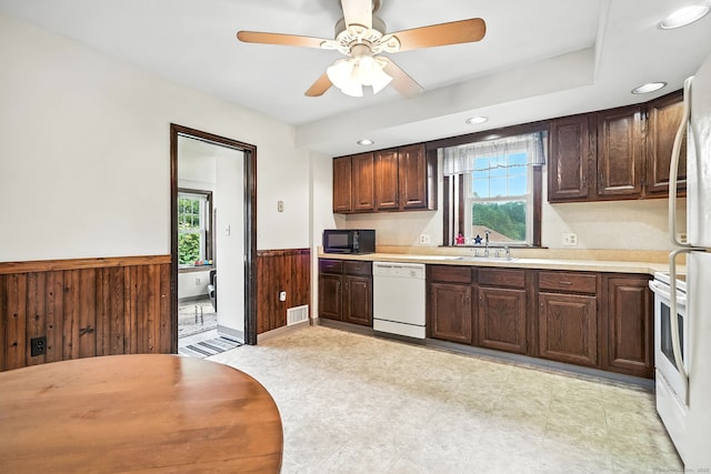 92 Yates St, West Haven, CT 06516 - kitchen featuring black microwave, dishwasher, wainscoting, light countertops, and healthy amount of natural light