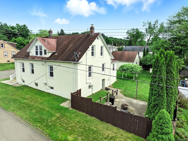 92 Yates St, West Haven, CT 06516 - view of side of home featuring stucco siding, an outdoor fire pit, roof with shingles, and a chimney